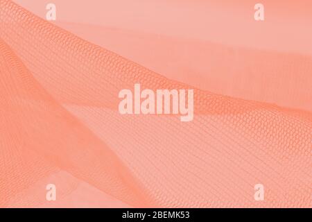Light small mesh fabric on light orange background Stock Photo