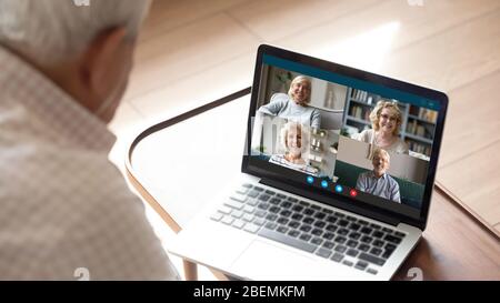 Senior man makes videocall talking with friends by videoconference application Stock Photo