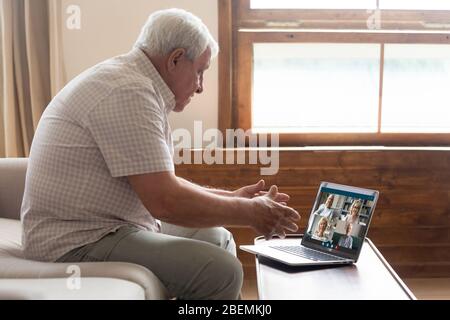 Grandfather talking with friends using pc webcam and videoconference app Stock Photo