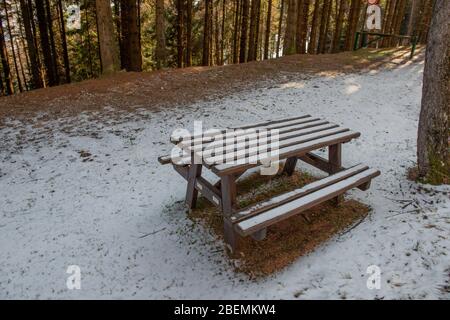 table with bench in the snowy park Stock Photo