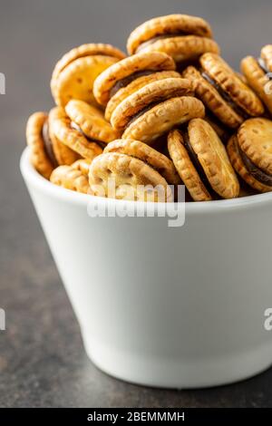 Mini cream sandwich cookies in bowl. Stock Photo