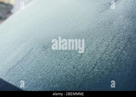 Raindrops on the hood of the car. Close-up. Stock Photo