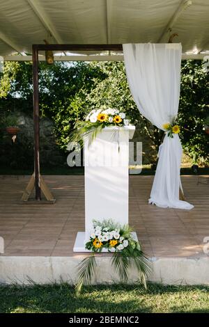 Wedding arch. Rustic wedding. Wedding area covered with flowers. Stock Photo