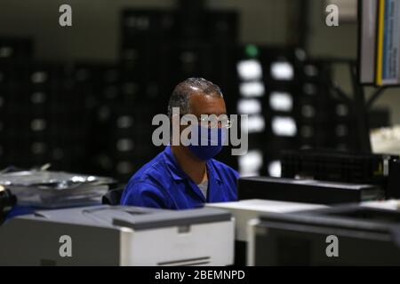 Manouba, Tunisia. 14th Apr, 2020. The factory's technician works at his desk during his daily work on Apr. 14, 2020 in Industrial Zone Agba, Manouba, Tunisia. After the announcement of total containment throughout Tunisia on March 22, 2020, factories and viral sectors are continuing their activities while respecting the precautions against the pandemic of CoViD-19. This story follows the daily routine of workers at Marquardt Tunisia automotive factory in Manouba, Tunisia during the Covid-19 coronavirus pandemic. (Photo by Mohamed Krit/Sipa USA) Credit: Sipa USA/Alamy Live News Stock Photo