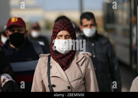 Manouba, Tunisia. 14th Apr, 2020. Workers wear face masks while arriving at factory on Apr. 14, 2020 in Industrial Zone Agba, Manouba, Tunisia. After the announcement of total containment throughout Tunisia on March 22, 2020, factories and viral sectors are continuing their activities while respecting the precautions against the pandemic of CoViD-19. This story follows the daily routine of workers at Marquardt Tunisia automotive factory in Manouba, Tunisia during the Covid-19 coronavirus pandemic. (Photo by Mohamed Krit/Sipa USA) Credit: Sipa USA/Alamy Live News Stock Photo