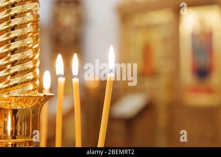 Orthodox Church. Christianity. Festive interior decoration with burning candles and icon in traditional Orthodox Church on Easter Eve or Christmas. Religion faith pray symbol