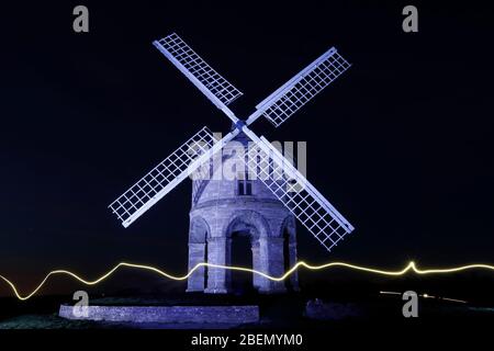 Chesterton, Warwickshire, UK. 14th April 2020. A light trail from a torch streams past Chesterton Windmill as it is illuminated blue in support of NHS staff and other key workers during the coronavirus pandemic lockdown. Credit Darren Staples/Alamy Live News. Stock Photo