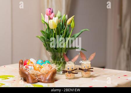 Easter holiday with colored eggs and flowers. colorful tulips near the painted Easter eggs of different colors Stock Photo