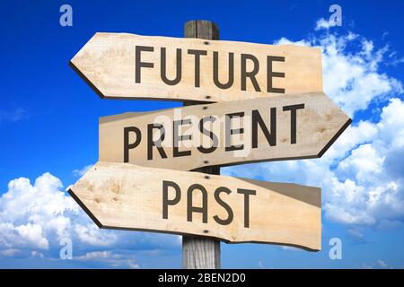 Wooden signpost with three arrows, sky Stock Photo