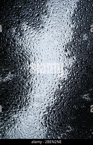 Raindrops Pooling on a Windshield in Forest Scene Stock Photo