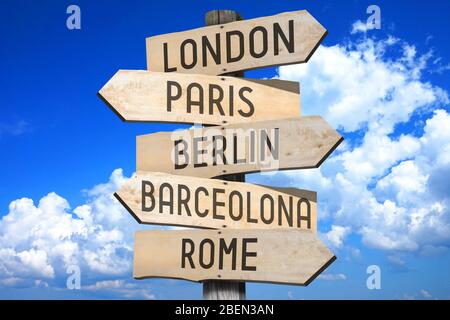 Wooden signpost with five arrows, sky Stock Photo