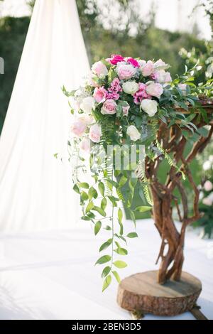 Wedding arch. Rustic wedding. Wedding area covered with flowers. Stock Photo