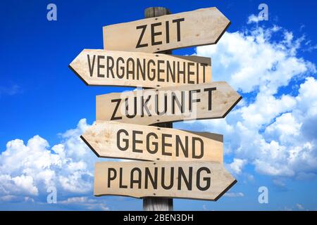 Wooden signpost with five arrows, sky Stock Photo