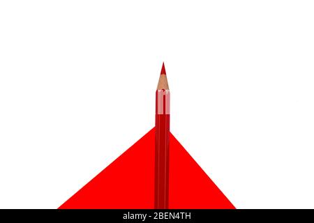 Top view of single wood pencil crayon of red color placed on top of a red white isolated background Stock Photo