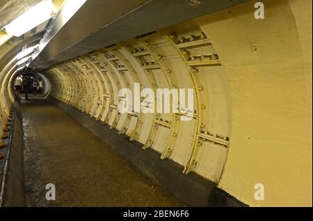 Steel lining added due to bomb damage in Greenwich foot tunnel under the river Thames linking to Island Gardens on the Isle of Dogs in London, UK Stock Photo