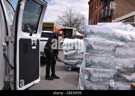 New York City, USA. 14th Apr, 2020. Volunteers ready food for distribution at the “Bed-sty Campaign Against Hunger” food pantry in the New York City borough of Brooklyn, NY, April 14, 2020. As millions lose their jobs due to the Coronavirus pandemic, food insecurity for many has become a real issue. (Anthony Behar/Sipa USA) Credit: Sipa USA/Alamy Live News Stock Photo