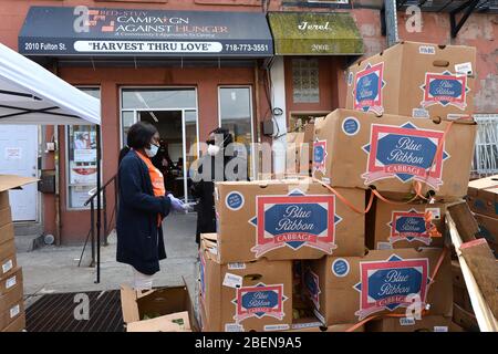 New York City, USA. 14th Apr, 2020. Volunteers ready food for distribution at the “Bed-sty Campaign Against Hunger” food pantry in the New York City borough of Brooklyn, NY, April 14, 2020. As millions lose their jobs due to the Coronavirus pandemic, food insecurity for many has become a real issue. (Anthony Behar/Sipa USA) Credit: Sipa USA/Alamy Live News Stock Photo