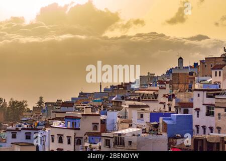 Blue and White Colored Homes and Buildings in Chefchaouen Morocco during a Golden Sunset Stock Photo
