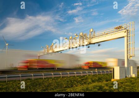 truck traffic under the highway gantry Stock Photo