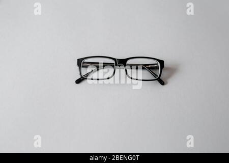 Folded fashion reading glasses for woman or unisex on white background Stock Photo