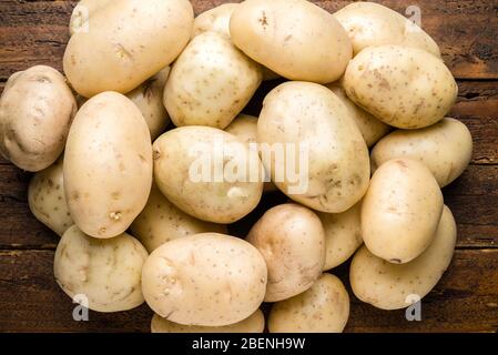 Top view fresh organic potatoes on wooden table top Stock Photo