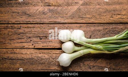 Top view fresh organic shallots on wooden table top Stock Photo