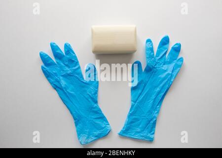 Pair of latex medical gloves, medical masks, sanitizer gel for hand hygiene, remedies, soap, disinfector. Coronavirus prevention Stock Photo