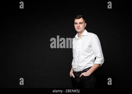 Thoughtful businessman looking at camera in studio Stock Photo