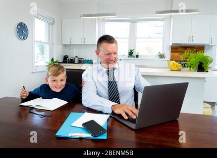 Coronavirus Outbreak schools and offices closing. Stressed parent trying to cope with remote work and homeschooling. COVID-19 pandemic forces shutdown Stock Photo