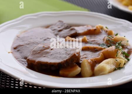 Croatian traditional cuisine, Pasticada With Gnocchi - Dalmatian Pot Roast or beef/ Croatian dish - Pasticada with gnocchi, beef stew in a sauce Stock Photo