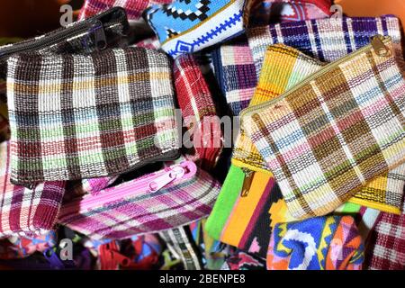 A pile of coin purses with checkered designs in different colors Stock Photo