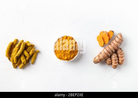 Fresh and dry root turmeric, curcuma powder in bowl on black table. Healthy spice immunity. Top view. Natural antiseptic. Stock Photo