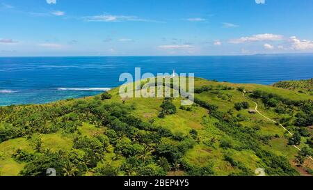 Lighthouse on a tropical island, top view. Beautiful landscape with a green island. Summer and travel vacation concept. Basot Island, Caramoan, Camarines Sur, Philippines. Stock Photo