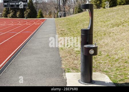 Public drinking water tap in school stadium. Sport recreation. Healthy lifestyle concept Stock Photo