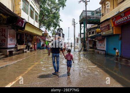 Man and his son in Varanasi flooded during the monsoon, India Stock Photo