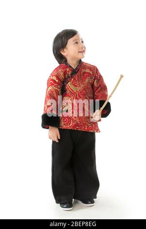 A little boy holding a lantern pole Stock Photo