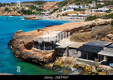 SAN JOSE, SPAIN - JUNE 15: A view of some fishermen shelters and the Cala Tarida beach on June 15, 2015, in San Jose, in Ibiza Island, Spain. Ibiza is Stock Photo