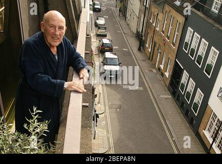 Sir Stirling Moss at home looking over his balcony at a $5m D-type