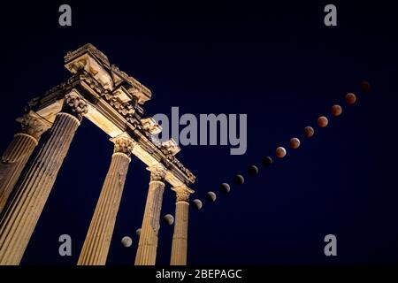 Total Lunar Eclipse over the Apollo Temple in Side, Turkey Stock Photo