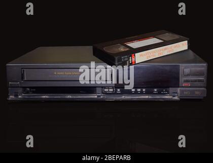 Rare Vintage Old Video Cassette Recorder or VCR with video tape over it. Stock Photo