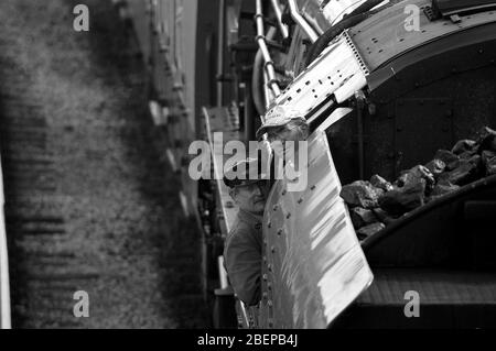 Ramsbottom, Lancashire, UK / August 24 2008: Steam train drivers peering out of the cab of a steam locomotive Stock Photo