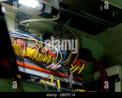 Automatic electrical connectors in power lines located inside of an industrial switch control panel board. Stock Photo