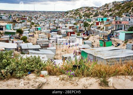 A view of the township called Khayelitsha on the outskirts of Cape Town, South Africa. The shacks sit on sandy soil and hillsides. It is one of the biggest townships in Africa. Stock Photo