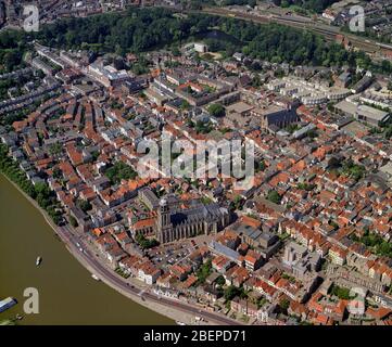 Deventer, Holland, July 11 - 1990: Historical aerial photo of the city Deventer situated on the east bank of the river IJssel and Lebuinuskerk in fron Stock Photo