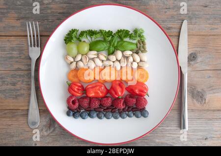 Varied vegan plant based diet ingredients including grains; nuts, fruits and vegetables Stock Photo