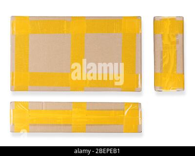 Cardboard package tied by yellow adhesive tape three views: top and sides. Isolated on white background Stock Photo