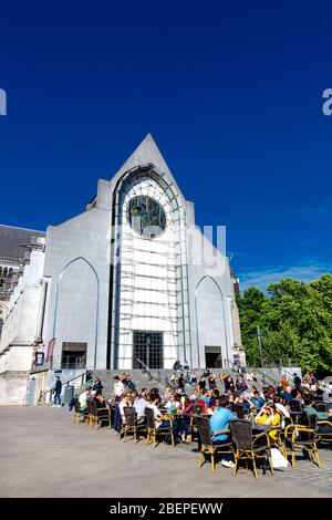 Lille Cathedral featuring a contemporary marble facade (Basilica of Notre Dame de la Treille) and people sitting al fresco in Lille, France Stock Photo