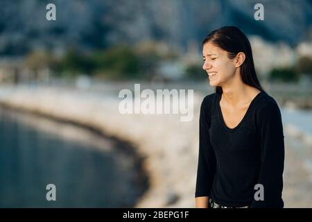 Stressed sad woman in bad mood overthinking problems,looking at the sea/ocean.Person being alone.Social distancing loneliness.Emotional challenge and Stock Photo