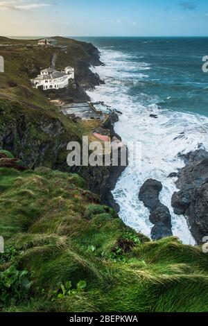 The large house known as Bakers Folly with the Lewinnick Lodge in the background on the rugged coast of Pentire Point East in Newquay in Cornwall. Stock Photo