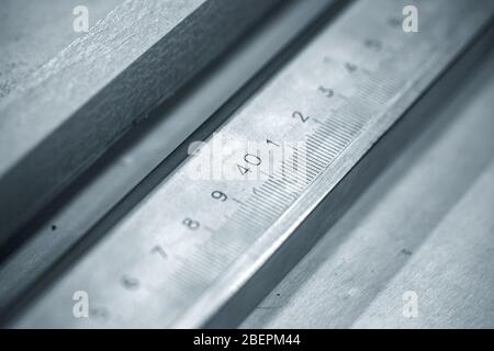 Calipers fragment with scale, blue toned close-up photo with selective focus on 40 mm size Stock Photo